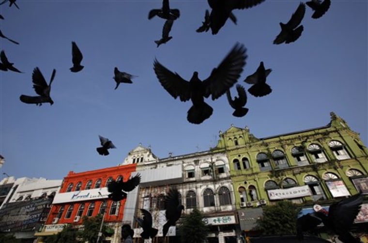 In this photo taken Saturday, Nov. 6, 2010, pigeons fly near a tourist spot in Yangon, Myanmar. The release of pro-democracy leader Aung San Suu Kyi from house arrest in November appears to be opening the way for more tourists by easing concerns that visiting the country is a signal of support for Myanmar's military dictatorship. (AP Photo)